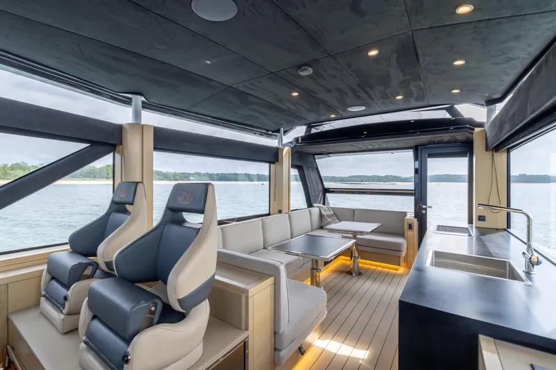 Grit Yacht Photos Pics Luxurious interior of 2025 Steeler Bronson 67 Beachclub yacht with modern seating and panoramic views.