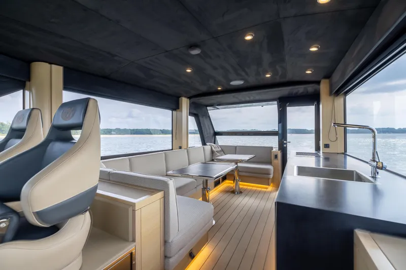 Grit Yacht Photos Pics Luxurious interior of 2025 Steeler Bronson 67 Beachclub yacht with modern seating and kitchen.