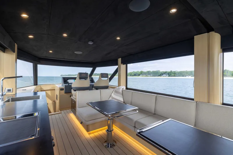 Grit Yacht Photos Pics Luxurious interior of 2025 Steeler Bronson 67 Beachclub yacht with modern seating and ocean view.
