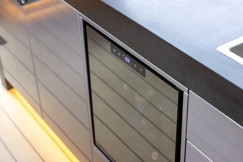 Grit Yacht Photos Pics Modern kitchen interior on Steeler Bronson 67 Beachclub yacht, featuring sleek cabinetry and built-in wine cooler.