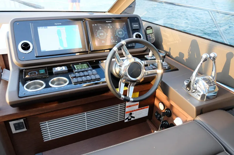  Yacht Photos Pics Helm of 2021 Prestige 590 Sport Fly yacht with modern navigation controls and displays.