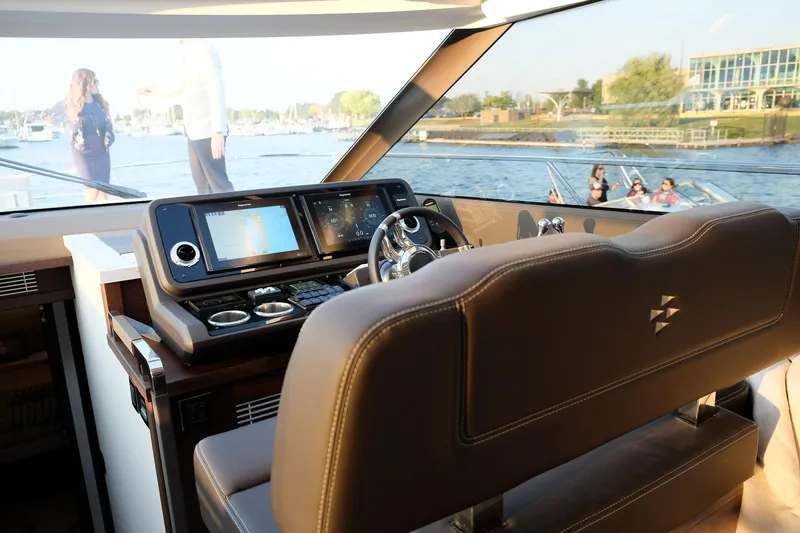  Yacht Photos Pics Prestige 590 Sport Fly 2021 yacht interior with modern dashboard and scenic water view.