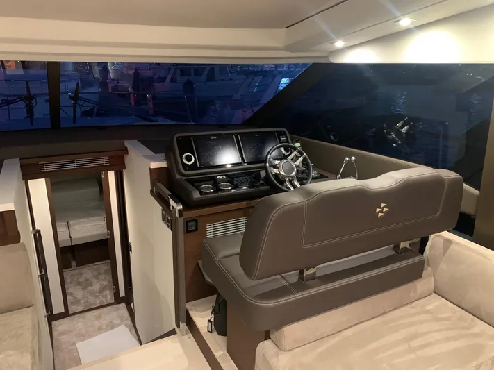  Yacht Photos Pics Luxurious interior of 2021 Prestige 590 Sport Fly yacht with modern helm station.
