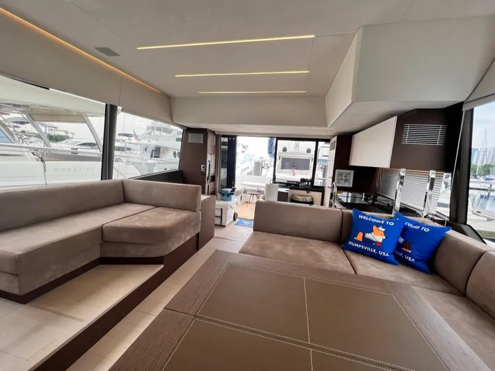  Yacht Photos Pics Luxurious interior of 2021 Prestige 590 Sport Fly yacht with plush seating and modern design.