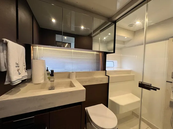  Yacht Photos Pics Luxurious bathroom interior of 2021 Prestige 590 Sport Fly yacht with modern fixtures.