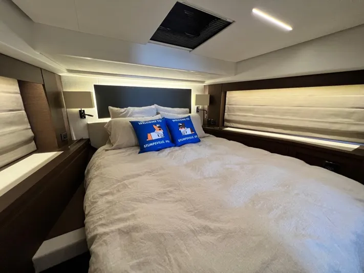  Yacht Photos Pics Luxurious bedroom interior of 2021 Prestige 590 Sport Fly yacht with cozy bedding.