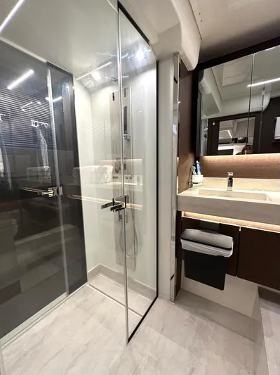  Yacht Photos Pics Luxurious bathroom in 2021 Prestige 590 Sport Fly yacht with modern shower and sleek vanity.