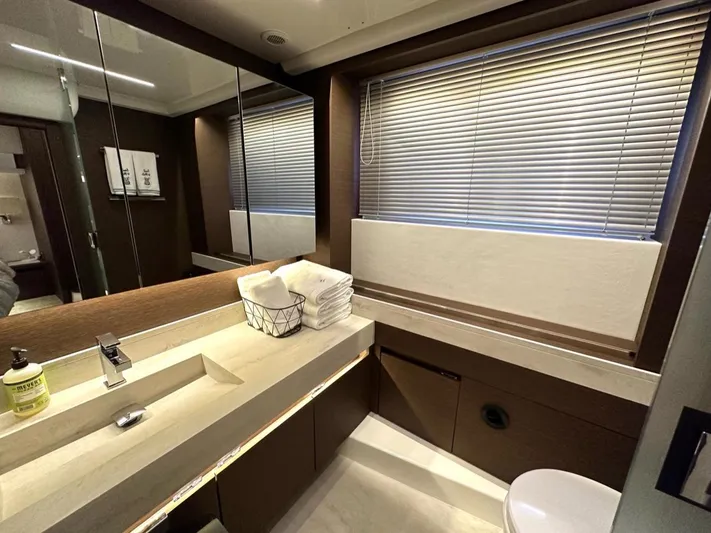  Yacht Photos Pics Luxurious bathroom in 2021 Prestige 590 Sport Fly yacht with modern fixtures and elegant design.