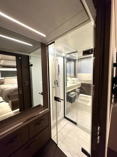  Yacht Photos Pics Luxurious bathroom interior of 2021 Prestige 590 Sport Fly yacht, featuring modern design and glass shower.