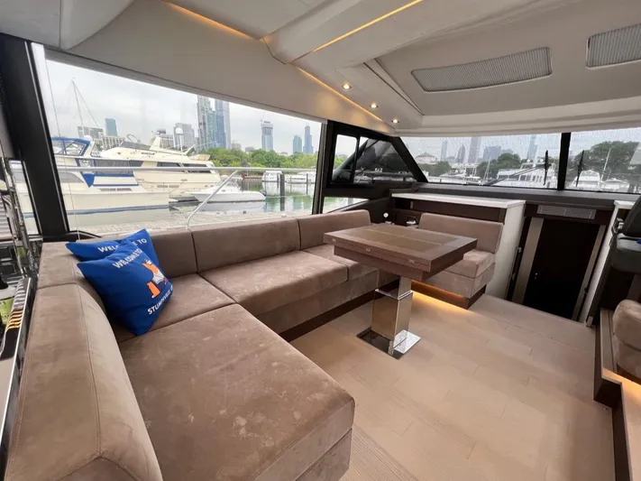  Yacht Photos Pics Luxurious interior of 2021 Prestige 590 Sport Fly yacht with plush seating and modern design.