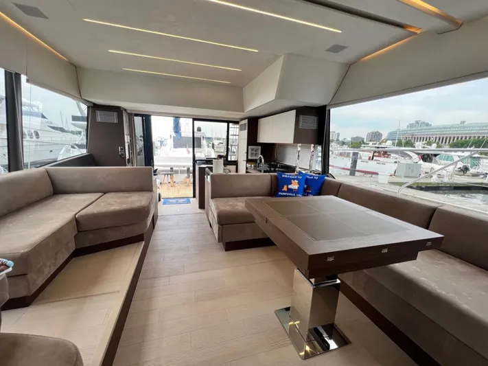  Yacht Photos Pics Luxurious interior of 2021 Prestige 590 Sport Fly yacht with elegant seating and dining area.