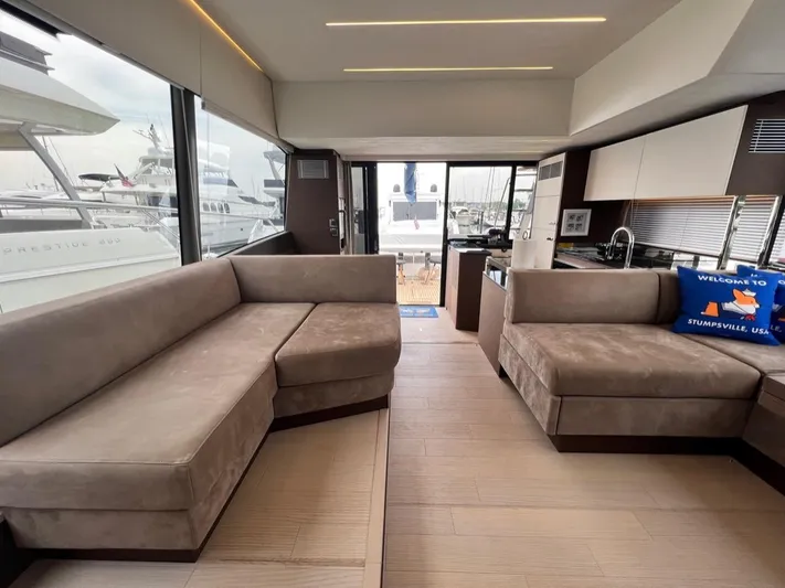  Yacht Photos Pics Luxurious interior of 2021 Prestige 590 Sport Fly yacht with plush seating and modern design.