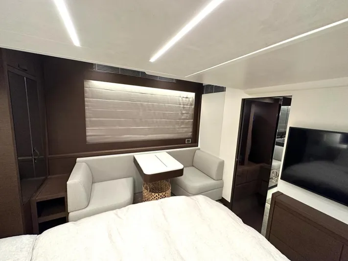  Yacht Photos Pics Luxurious interior of 2021 Prestige 590 Sport Fly yacht with modern seating and TV.