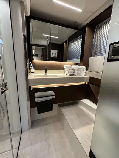  Yacht Photos Pics Luxurious bathroom interior of 2021 Prestige 590 Sport Fly yacht, featuring modern design and amenities.