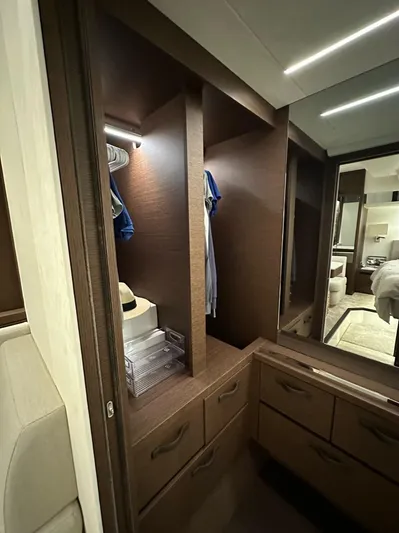  Yacht Photos Pics Luxurious wooden closet interior on a 2021 Prestige 590 Sport Fly yacht.