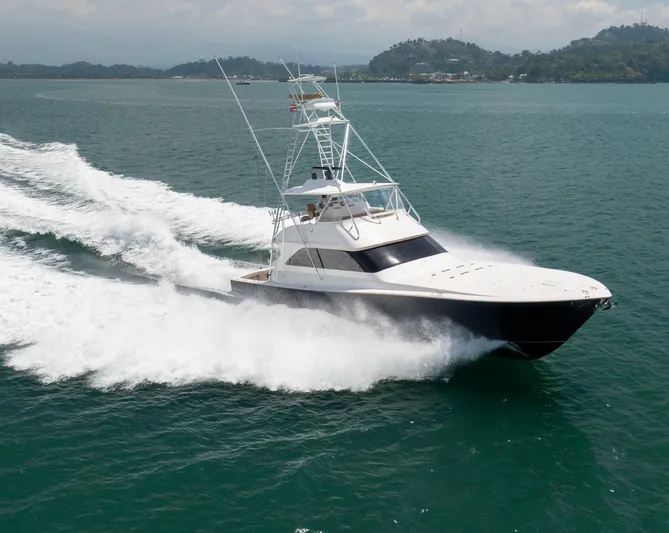 Relentless Yacht Photos Pics 2003 Viking 61 Convertible yacht cruising on open water, creating a dynamic wake.