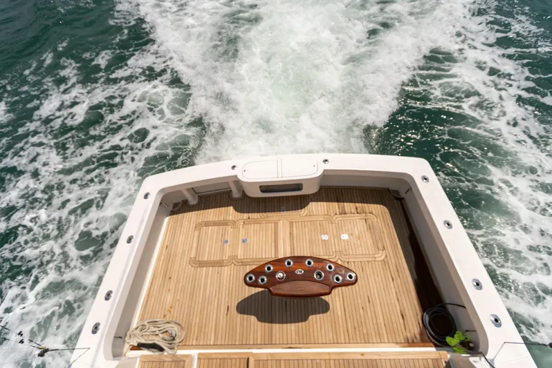 Relentless Yacht Photos Pics 2003 Viking 61 Convertible yacht deck with ocean wake in background.