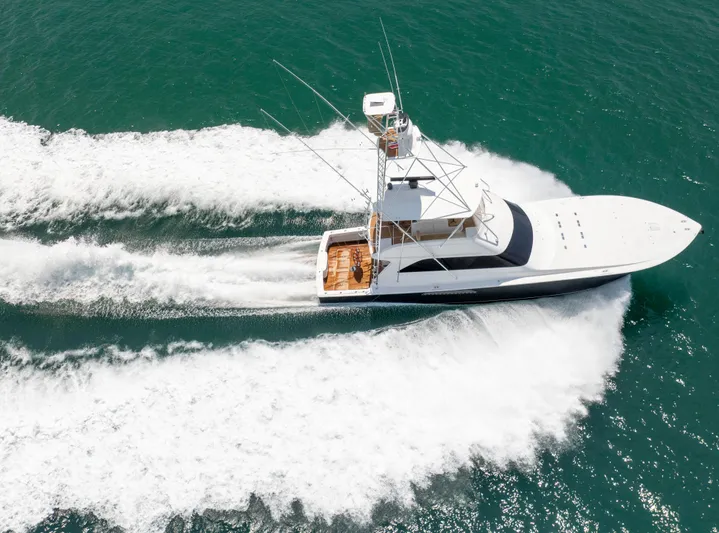 Relentless Yacht Photos Pics 2003 Viking 61 Convertible yacht cruising on open water, creating a dynamic wake.