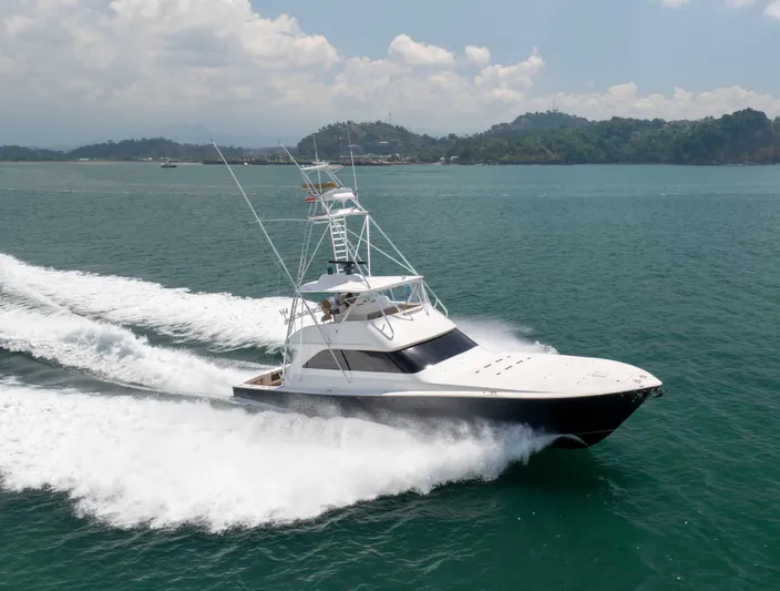 Relentless Yacht Photos Pics 2003 Viking 61 Convertible yacht cruising on open water, surrounded by scenic landscape.