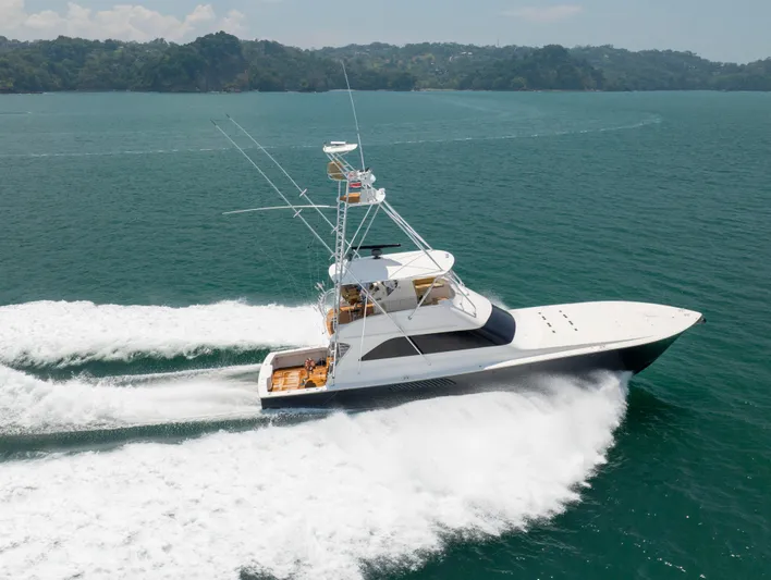 Relentless Yacht Photos Pics 2003 Viking 61 Convertible yacht cruising on open water, creating a dynamic wake.