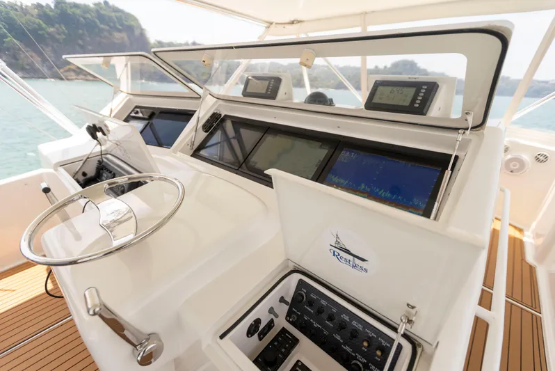 Relentless Yacht Photos Pics Helm of 2003 Viking 61 Convertible yacht with navigation equipment and controls.