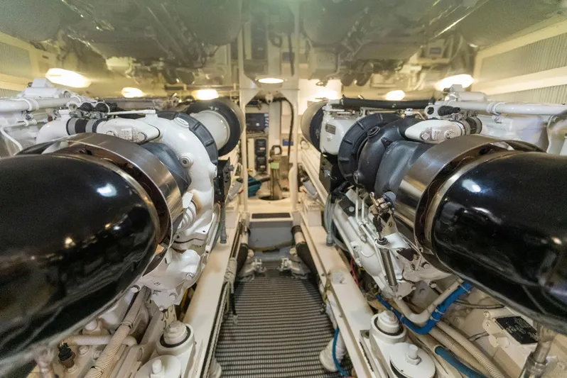 Relentless Yacht Photos Pics Engine room of a 2003 Viking 61 Convertible yacht, showcasing dual engines and mechanical systems.