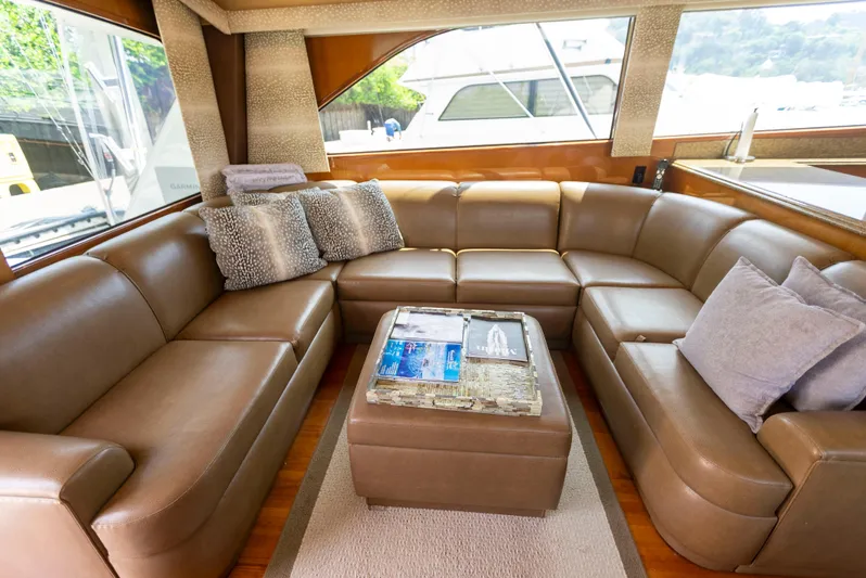 Relentless Yacht Photos Pics Luxurious interior of a 2003 Viking 61 Convertible yacht with leather seating and cushions.