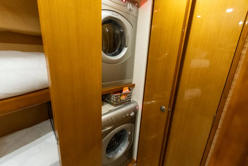 Relentless Yacht Photos Pics Laundry area in 2003 Viking 61 Convertible yacht with stacked washer and dryer.