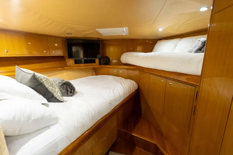 Relentless Yacht Photos Pics Luxurious cabin interior of a 2003 Viking 61 Convertible yacht with cozy bedding.