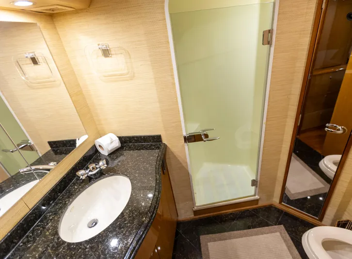 Relentless Yacht Photos Pics Luxurious bathroom in 2003 Viking 61 Convertible yacht with granite countertop and glass shower.