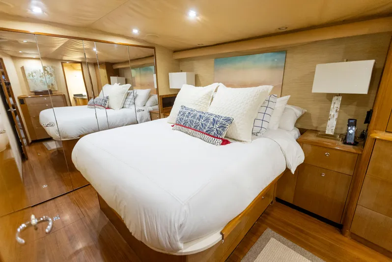 Relentless Yacht Photos Pics Luxurious bedroom interior of 2003 Viking 61 Convertible yacht with mirrored closet.