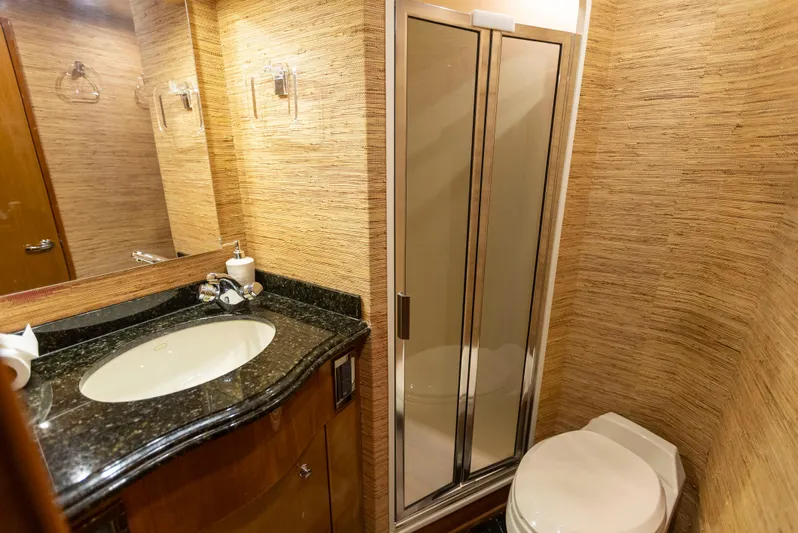 Relentless Yacht Photos Pics Luxurious bathroom in 2003 Viking 61 Convertible yacht with modern fixtures and elegant design.