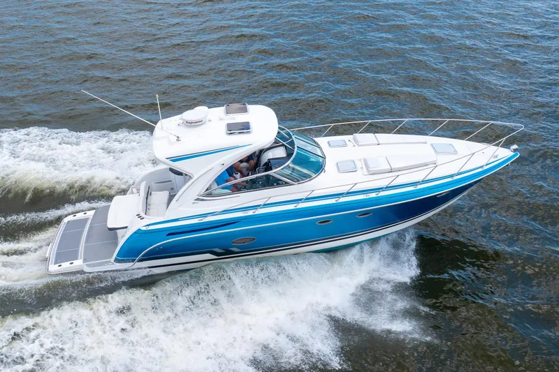 Rum Punch It Yacht Photos Pics 2018 Formula 37 Performance Cruiser speeding on open water, showcasing sleek design and vibrant blue accents.