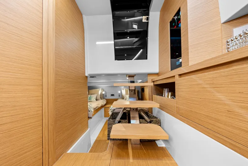 Bote Coco Yacht Photos Pics Interior of 2023 Pardo Yachts P38, featuring modern wooden design and cozy seating area.