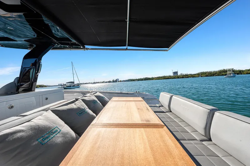 Bote Coco Yacht Photos Pics 2023 Pardo Yachts P38 deck with seating, table, and scenic water view.