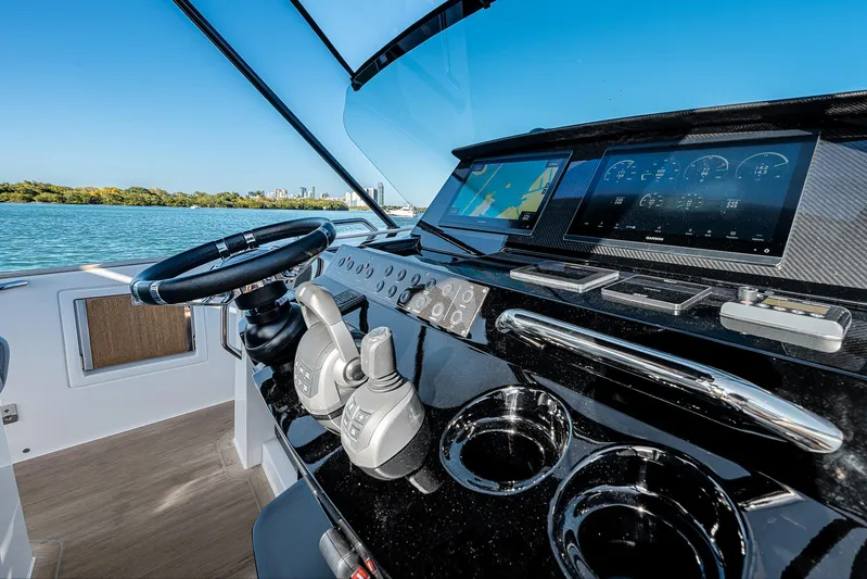 Bote Coco Yacht Photos Pics 2023 Pardo Yachts P38 helm with modern controls and navigation screens, overlooking serene waters.