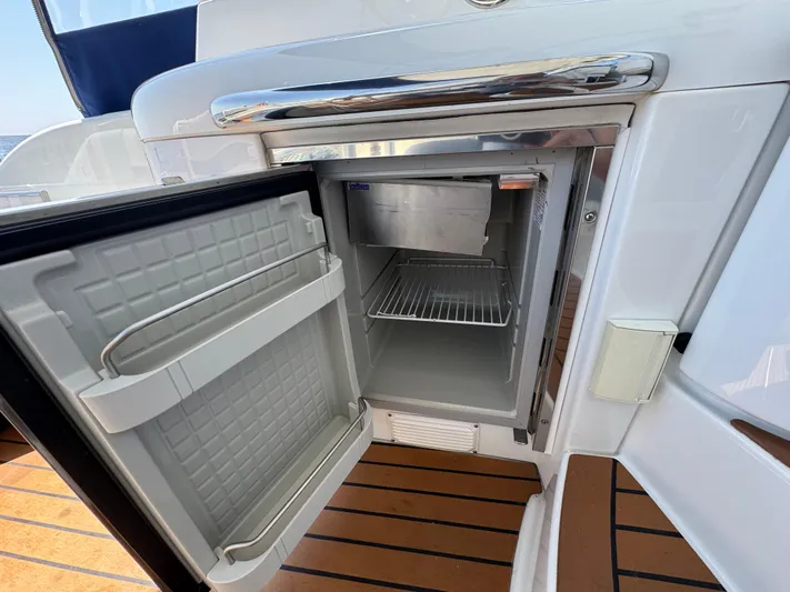  Yacht Photos Pics Open mini fridge on 2008 Formula 40 PC yacht, showcasing interior shelves and sleek design.