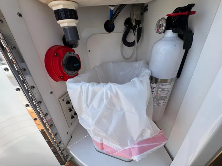  Yacht Photos Pics Fire extinguisher and waste bin in 2008 Formula 40 PC boat compartment.
