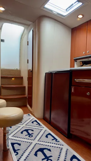  Yacht Photos Pics Interior of 2008 Formula 40 PC yacht with wooden cabinetry and nautical-themed rug.