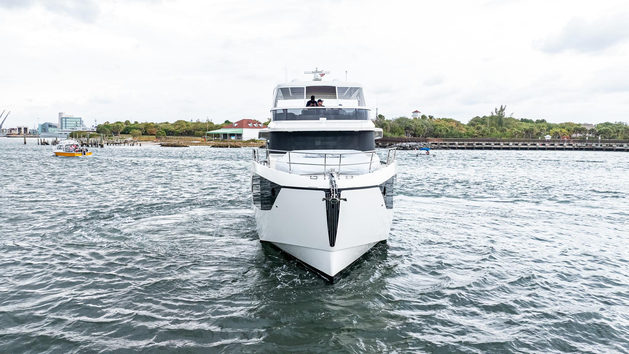 2024 Absolute 68 NAVETTA yacht cruising on open water, front view.