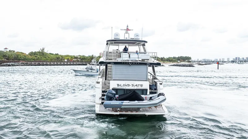 Available Now Yacht Photos Pics 2024 Absolute 68 NAVETTA yacht cruising on a scenic waterway.