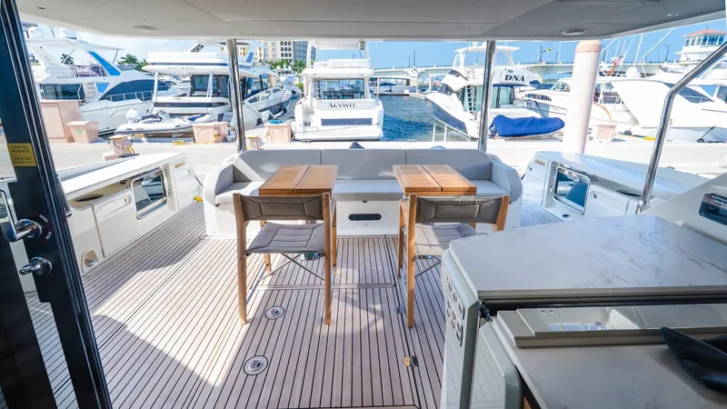 Available Now Yacht Photos Pics Luxurious deck of 2024 Absolute 68 NAVETTA yacht, featuring elegant seating and marina view.