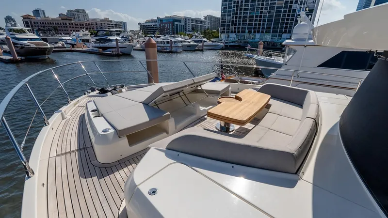 Available Now Yacht Photos Pics Luxurious 2024 Absolute 68 NAVETTA yacht with elegant deck seating in a marina setting.