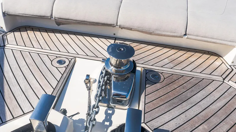 Available Now Yacht Photos Pics 2024 Absolute 68 NAVETTA yacht deck with winch and chain on wooden flooring.
