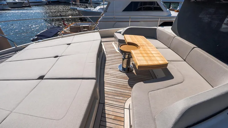Available Now Yacht Photos Pics Luxurious 2024 Absolute 68 NAVETTA yacht deck with elegant seating and wooden table.