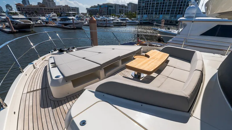 Available Now Yacht Photos Pics Luxurious 2024 Absolute 68 NAVETTA yacht with spacious sun deck and elegant seating in marina.