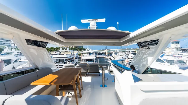 Available Now Yacht Photos Pics Luxurious 2024 Absolute 68 NAVETTA yacht deck with seating and marina view.