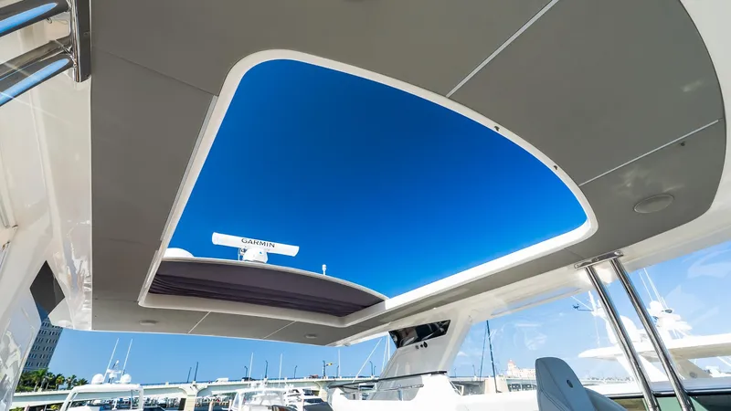 Available Now Yacht Photos Pics 2024 Absolute 68 NAVETTA yacht with open sunroof, showcasing clear blue sky.