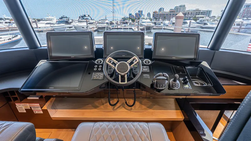 Available Now Yacht Photos Pics Helm of 2024 Absolute 68 NAVETTA yacht with modern navigation screens and controls.