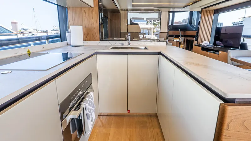 Available Now Yacht Photos Pics Modern kitchen interior on 2024 Absolute 68 NAVETTA yacht, featuring sleek countertops and appliances.